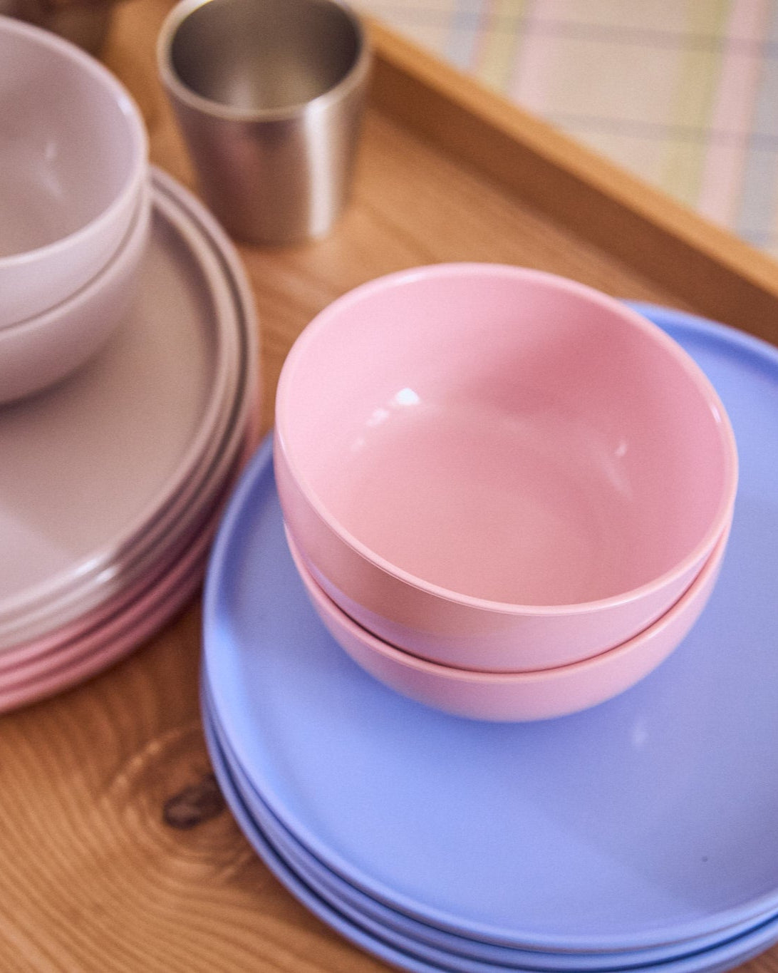 pink blue and gray plates and bowls