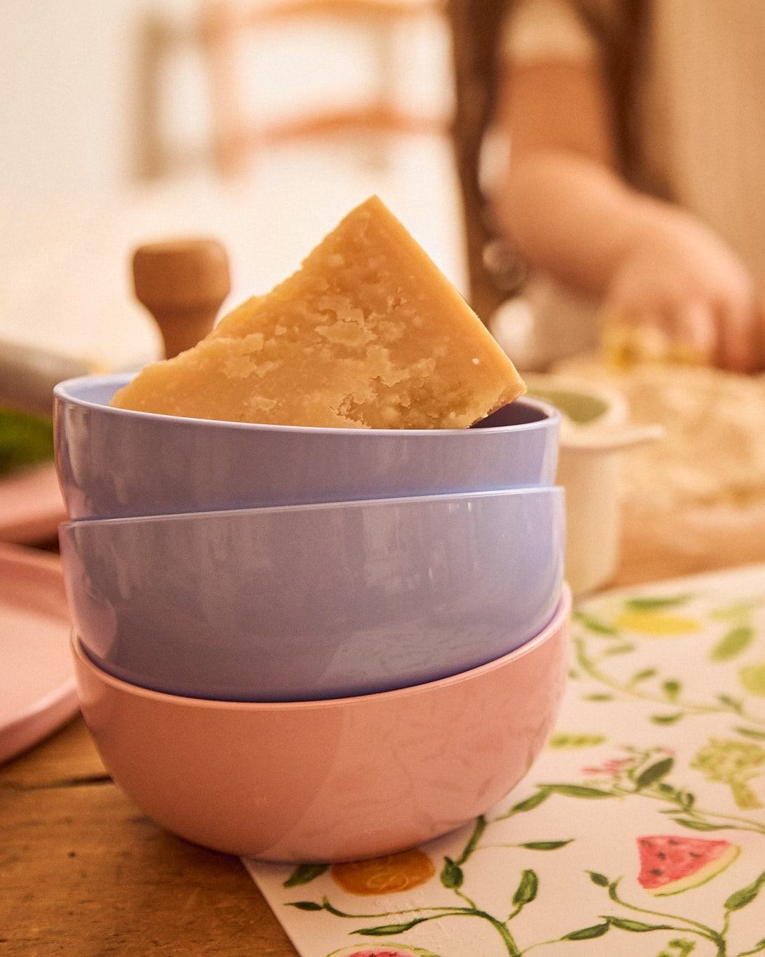 Pastel bowls on a warm wooden table