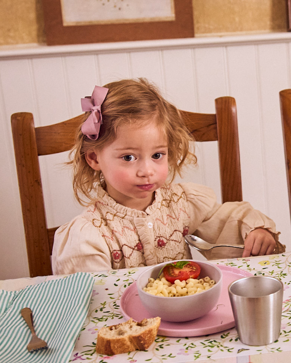 cute toddler eating mac and cheese in pastel recette dinnerware