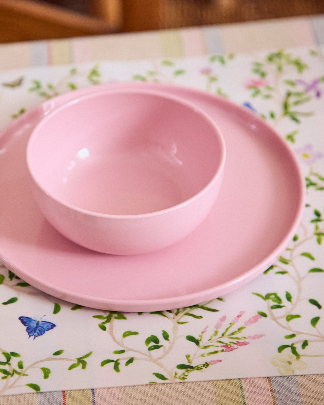 Pink plate and bowl on a floral placemat