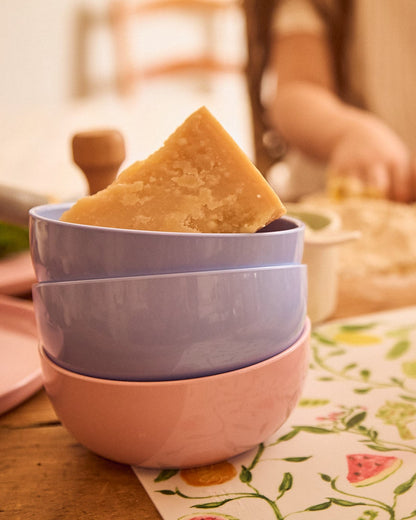 Pastel bowls on a warm wooden table