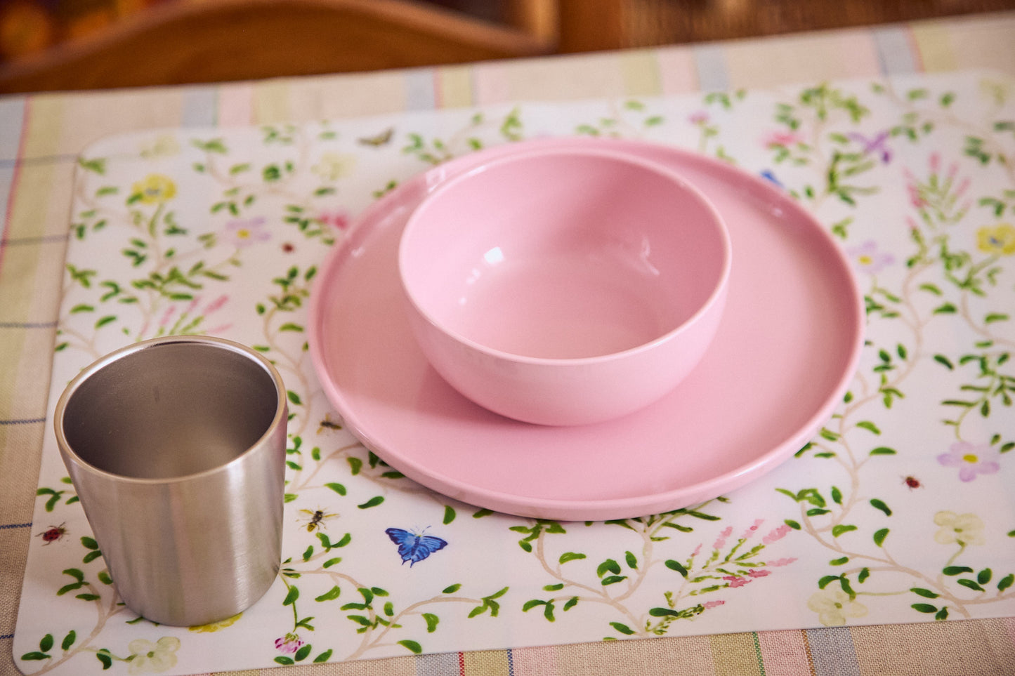 pink children's tableware with floral placemat