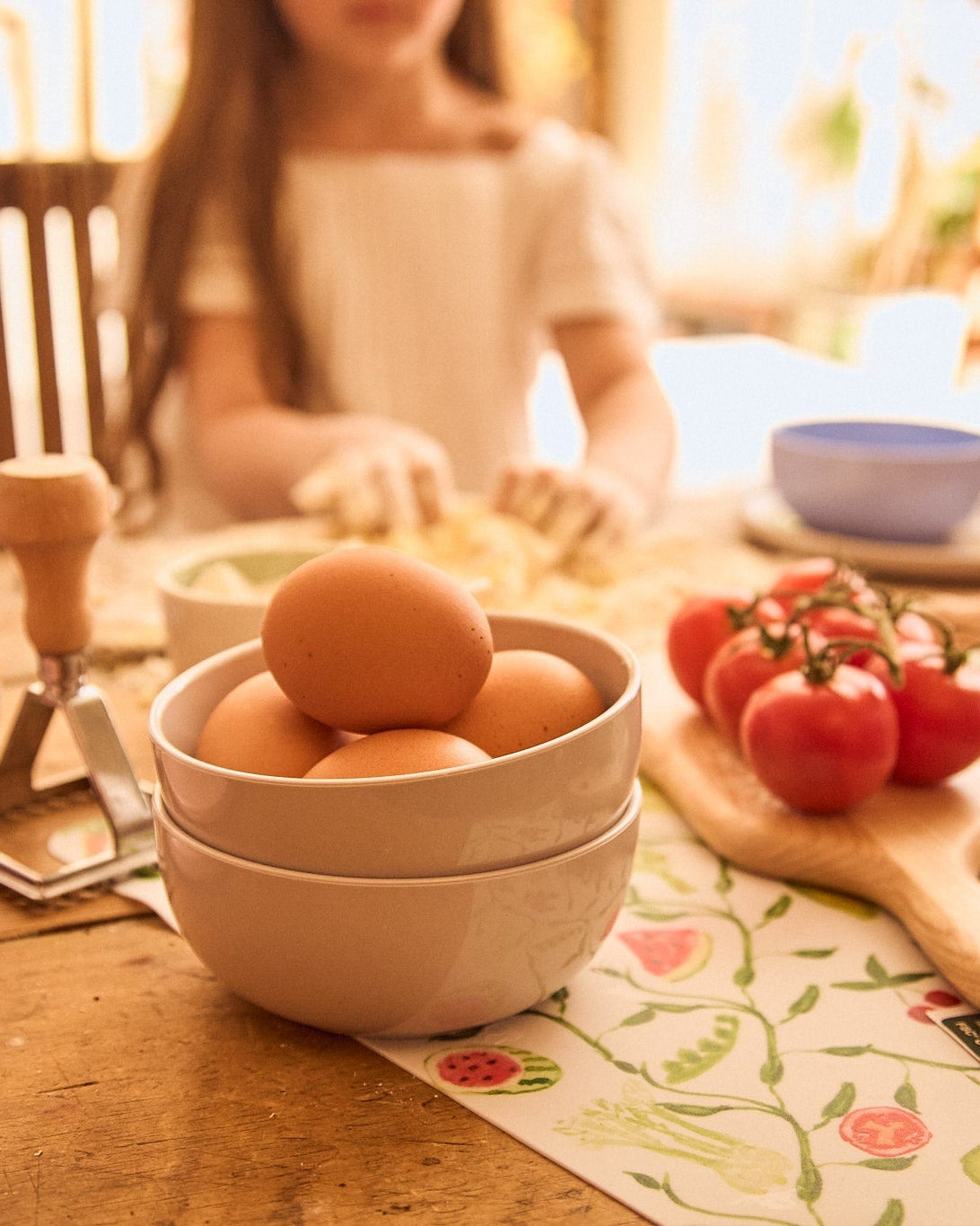 Two neutral bowls with fresh eggs on a sunny warm day